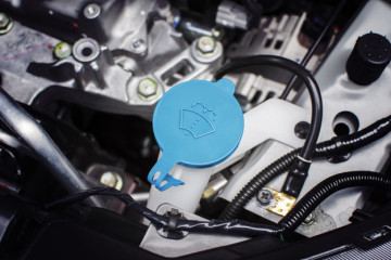 Windshield washer fluid cap with blue color in engine room of ca